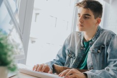 young teenager or student with the computer on the desktop